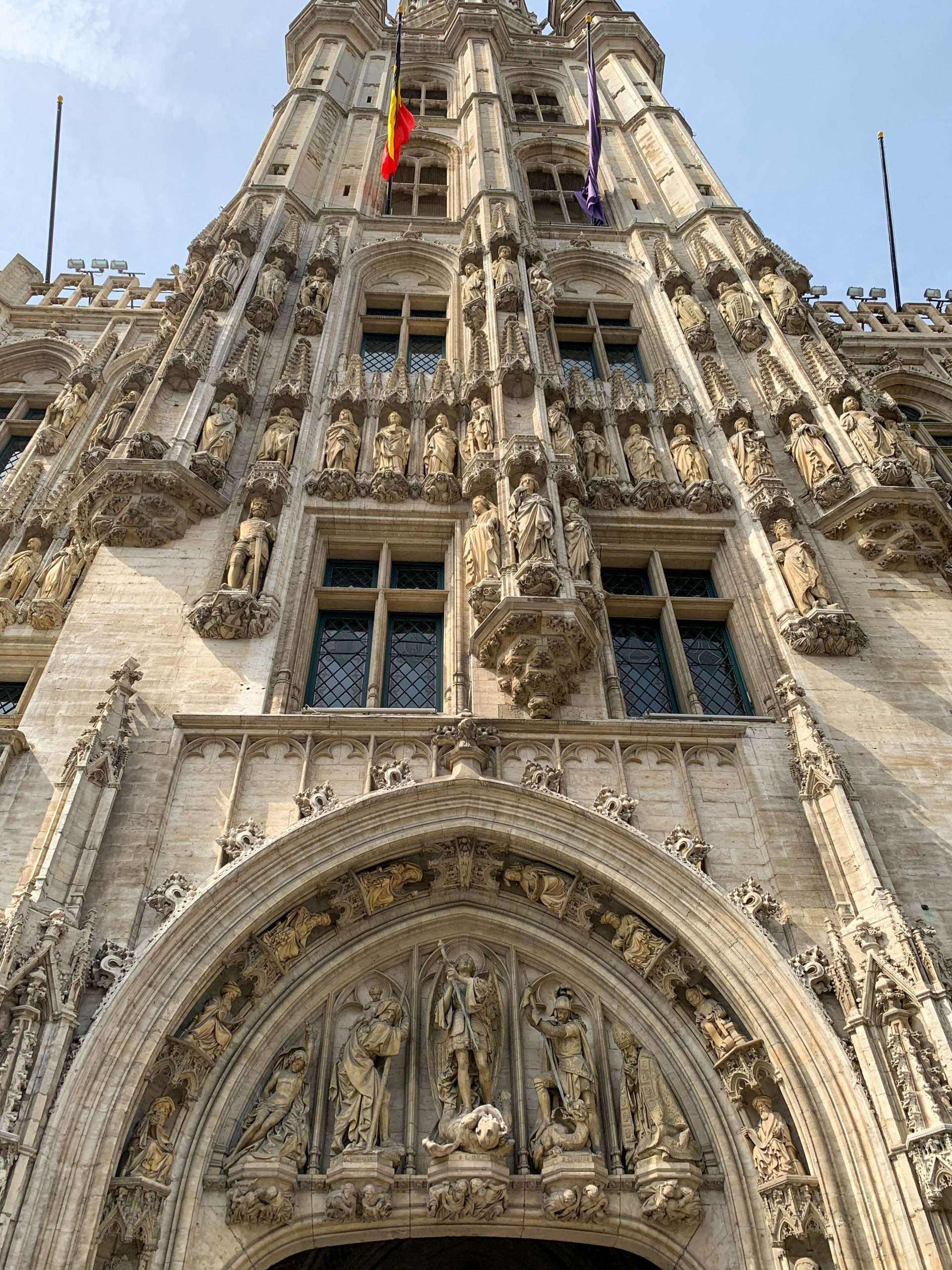 Image shows the façade and statues of the Town Hall in the Grand Place in Brussels 