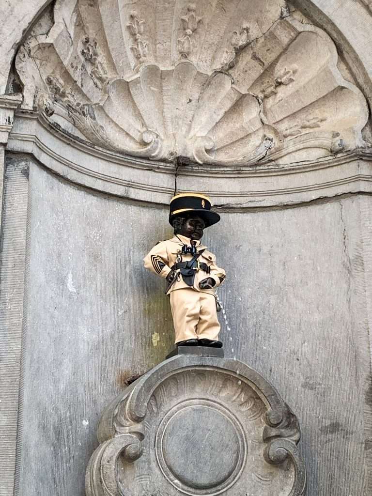 Image shows the famous statute of a urinating boy, Manneken Pis, in Brussels 