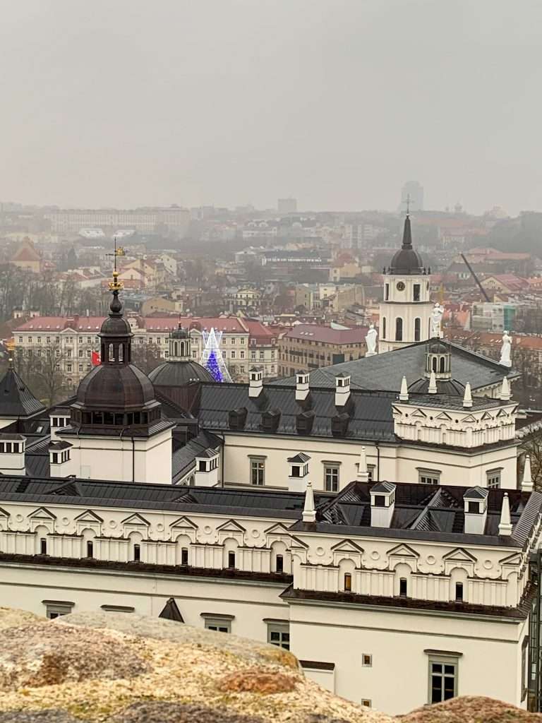 Image shows the view overlooking Vilnius as seen from Gediminas Tower on the hill above the city. The top of the Vilnius Christmas tree can also be seen.
