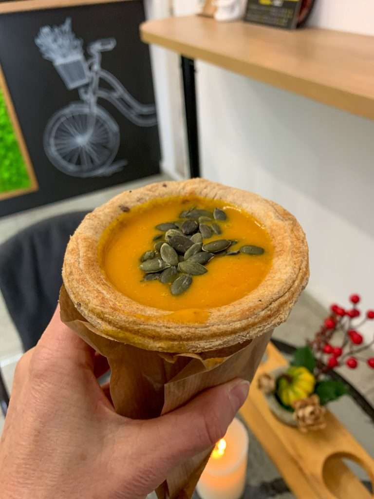 Image shows soup in an edible cup purchased from Soup Culture in Bratislava