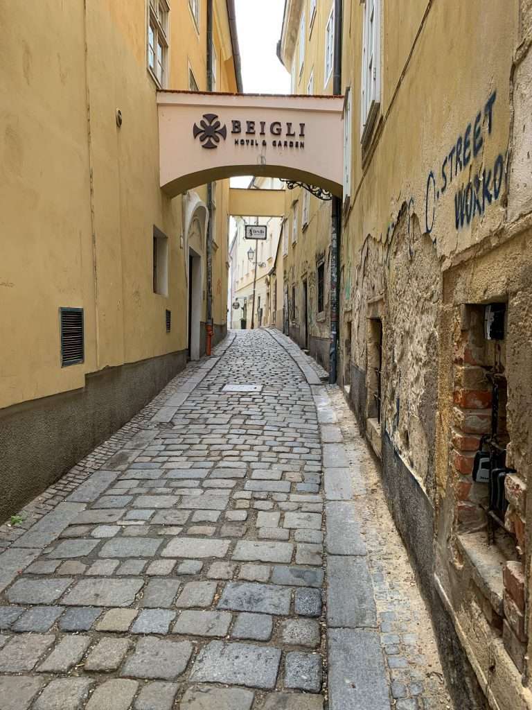 Image shows a street scene in the Old Town in Bratislava. Exploring the historic Old Town is something to add to an itinerary for 3 days in Bratislava