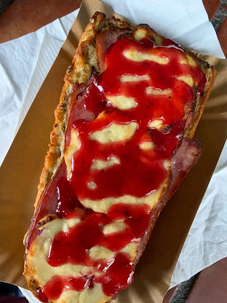 Image shows a slice of traditional Polish pizza, Zapiekanka. One of the best things to eat in Krakow