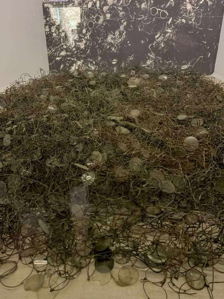Image shows the piles of spectacles at Auschwitz. These are an emotional scene for those visiting Auschwitz