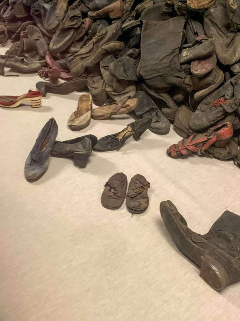 Image shows the piles of shoes at Auschwitz. These are another emotional scene for those visiting Auschwitz