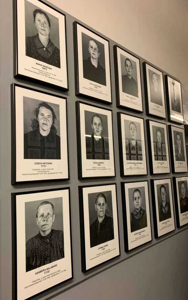 Image shows walls of photos of prisoners held at Auschwitz