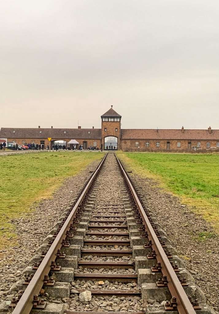 Image shows the entrance gates to Auschwitz II - Birkenau, known as the Gates of Hell.