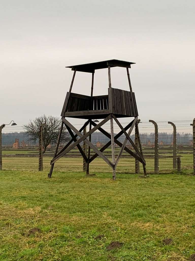 Image shows a view of Auschwitz II watchtower seen on a visit to Auschwitz