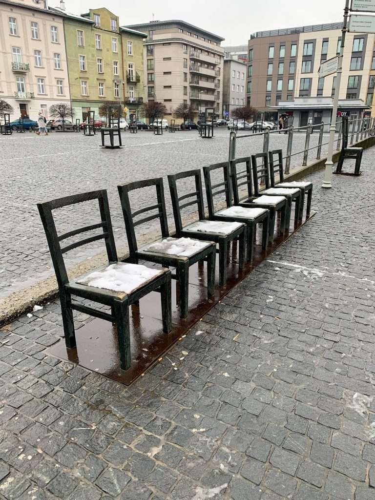 Image shows some of the scattered bronze chairs which are a memorial to the liquidation of the Jewish ghetto in 1943, one of the best things to see in Krakow
