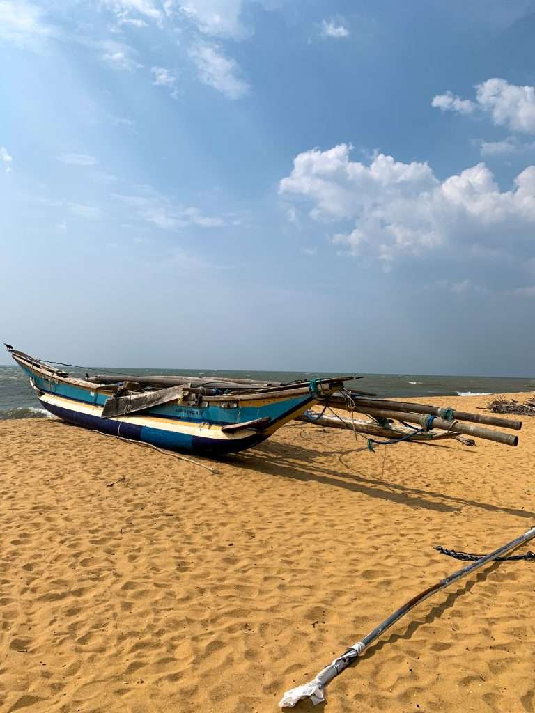 Image shows traditional boats on the beach in Negombo, one of the best places to visit in Sri Lanka 