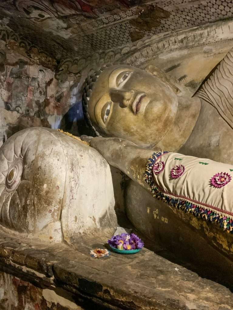 Image shows part of a statue of Buddha within the Dambulla Cave complex.