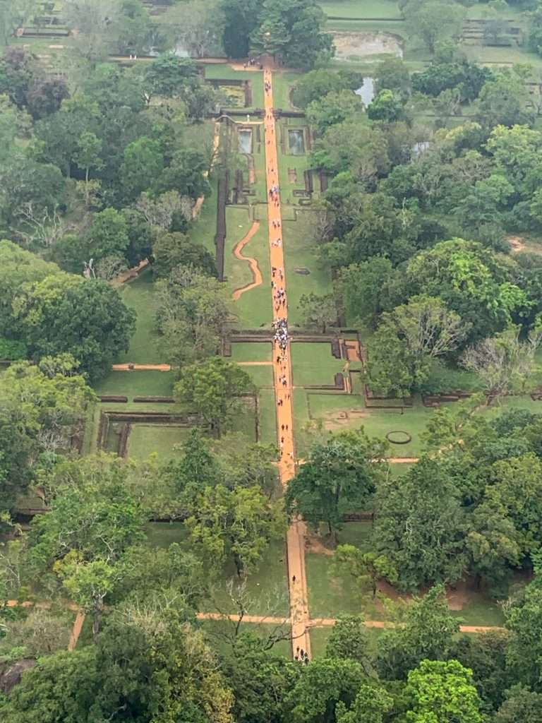 Image shows the view from the top of Lion Rock in Sri Lanka looking down over the entranceway and pathway to the Rock. 