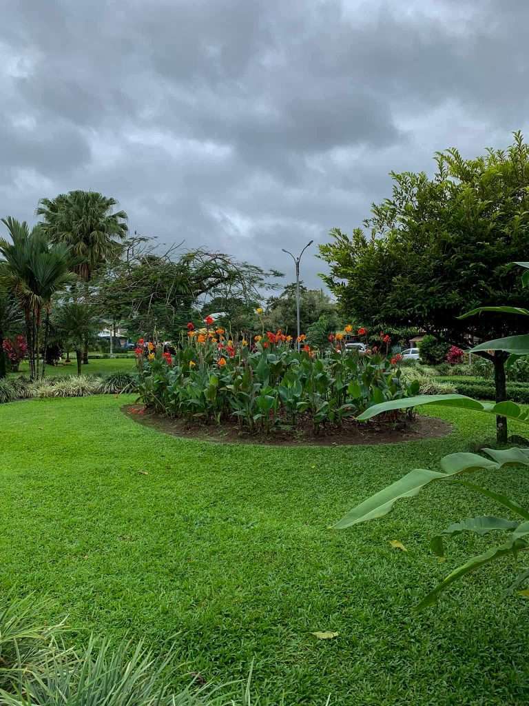 Image shows a view of the gardens in the town square in La Fortuna, not far from the Arenal Volcano in Costa Rica.