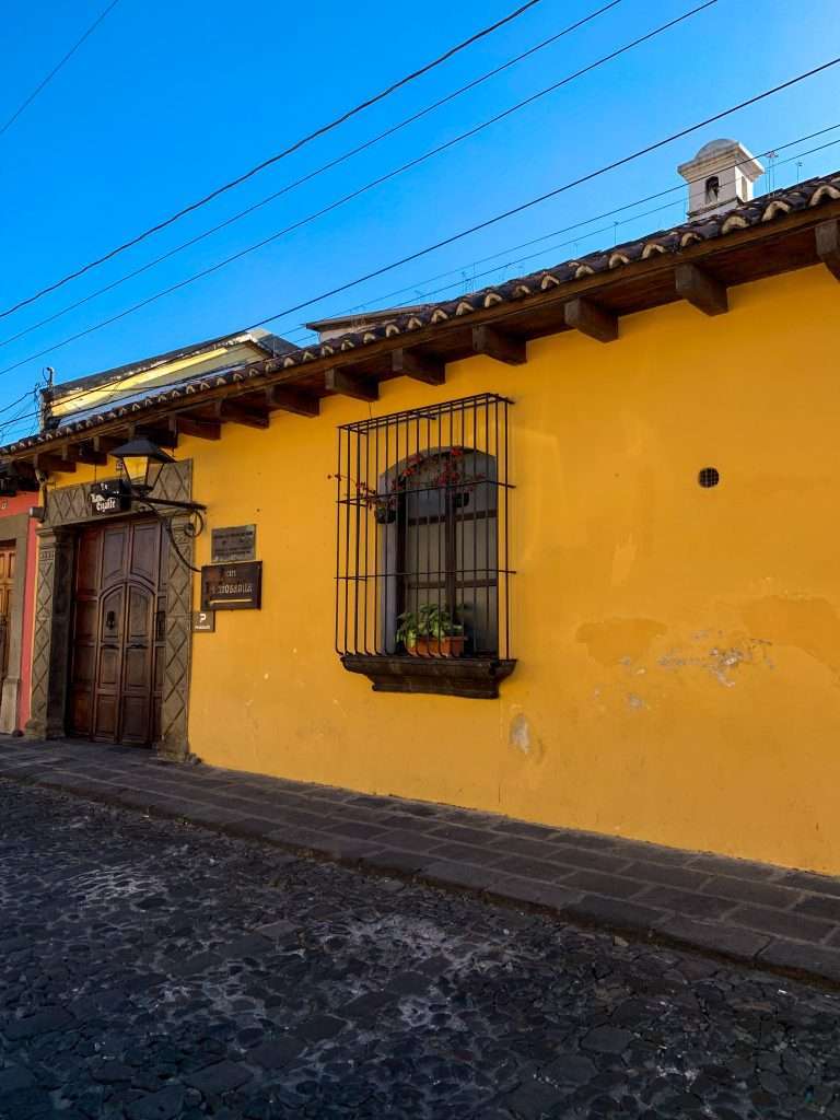 Image shows one of the colourful Colonial architecture to be seen during a day in Antigua