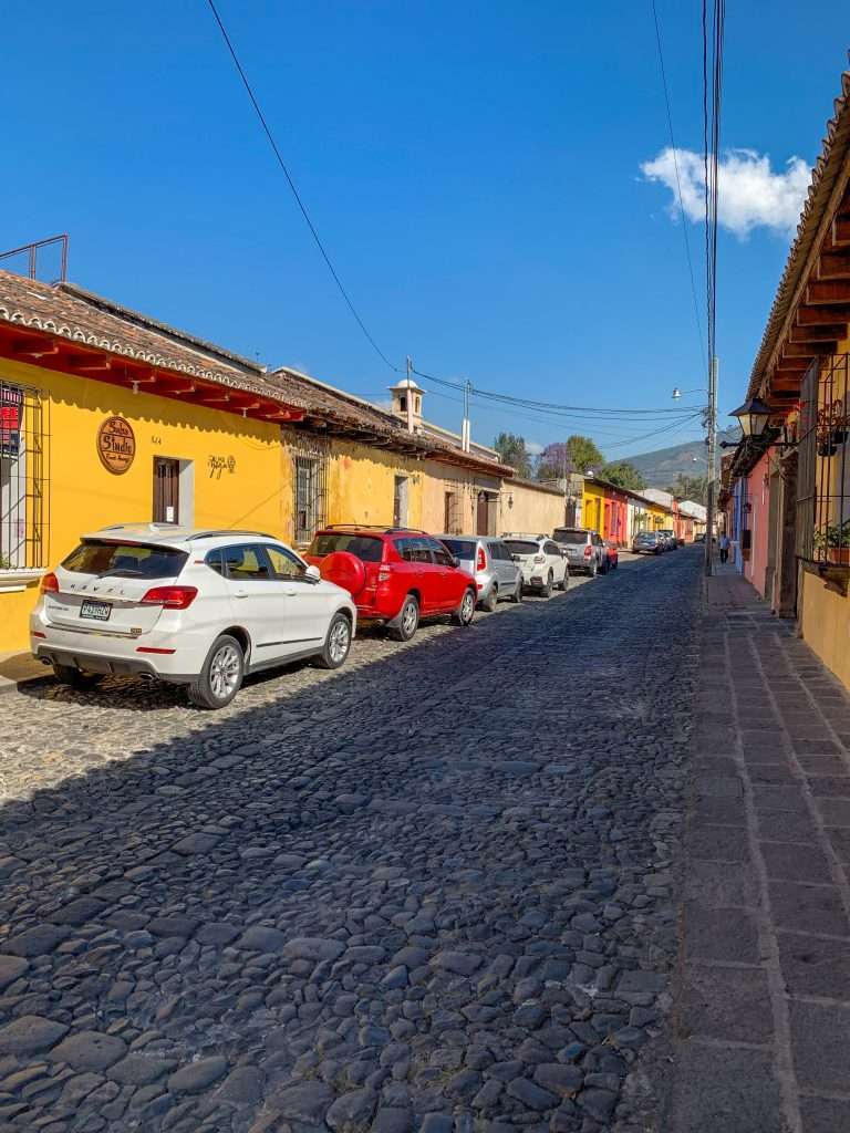 Image shows one of the colourful Colonial architecture to be seen during a day in Antigua