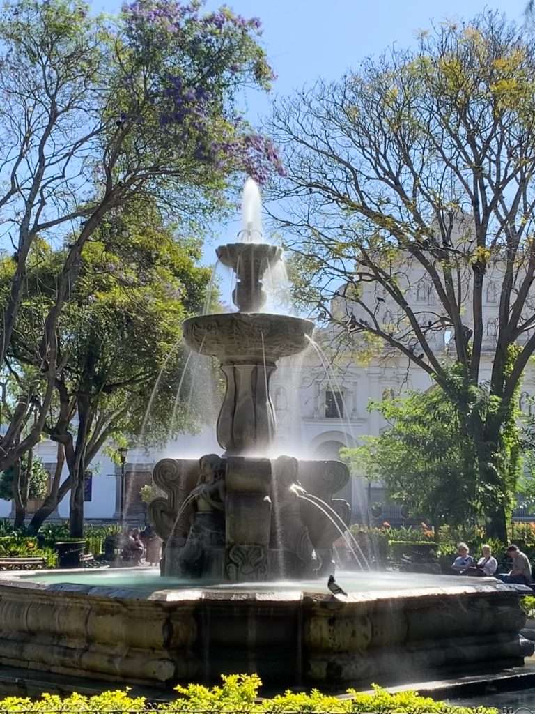 Image shows the fountain located within Parque Central in Antigua Guatemala.