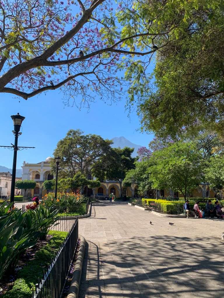 Image shows a view within Parque Central in Antigua Guatemala. Sitting in Parque Central is a perfect way to spend some time during one day in Antigua.