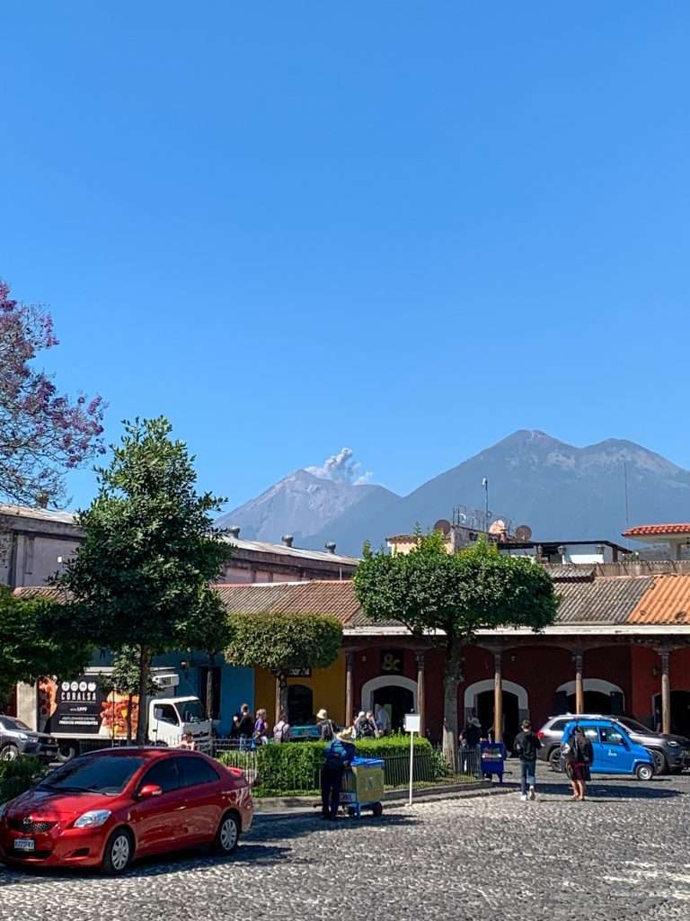 Image shows the Fuego Volcano in Antigua Guatemala with ash spewing from its crater.