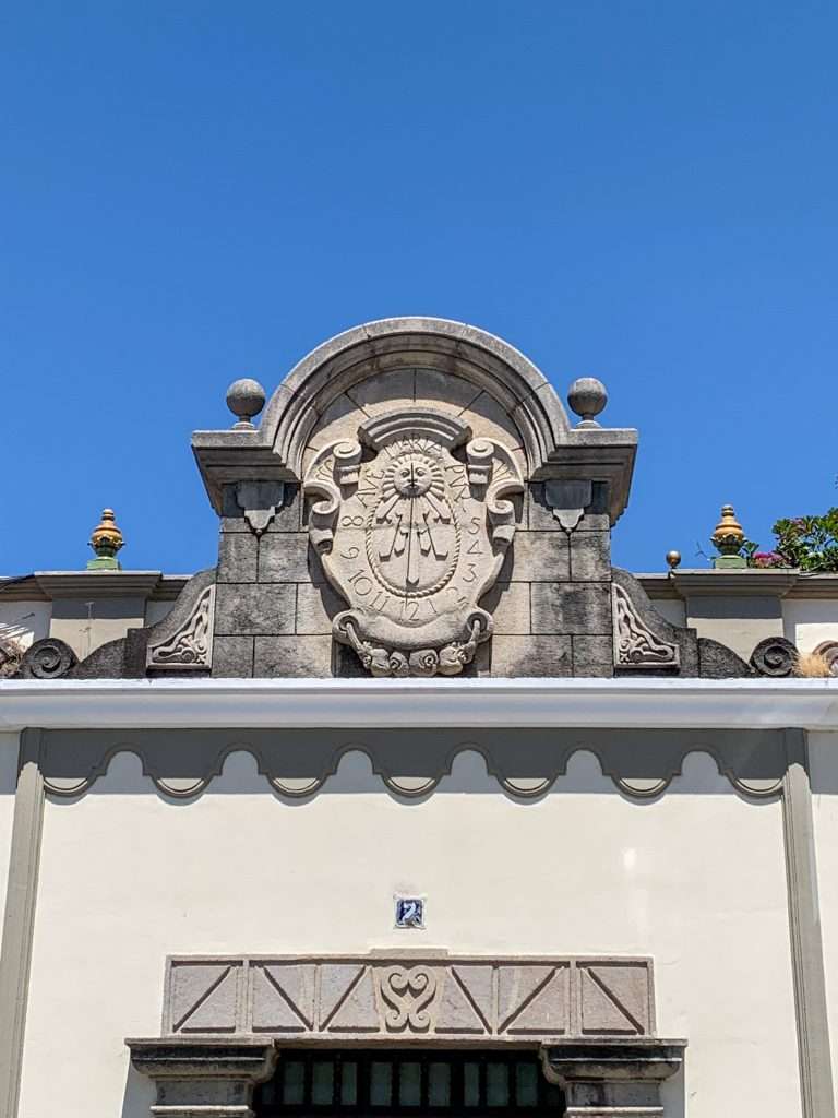 Image shows a sundial on a building. The photo was captured during a walking tour in Antigua Guatemala