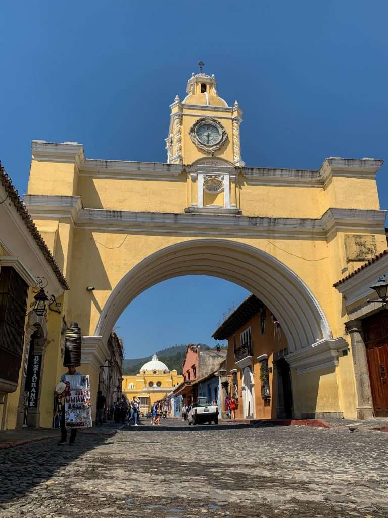 Image shows the famous Santa Catalina Arch in Antigua Guatemala. This is a must visit site when spending a day in Antigua