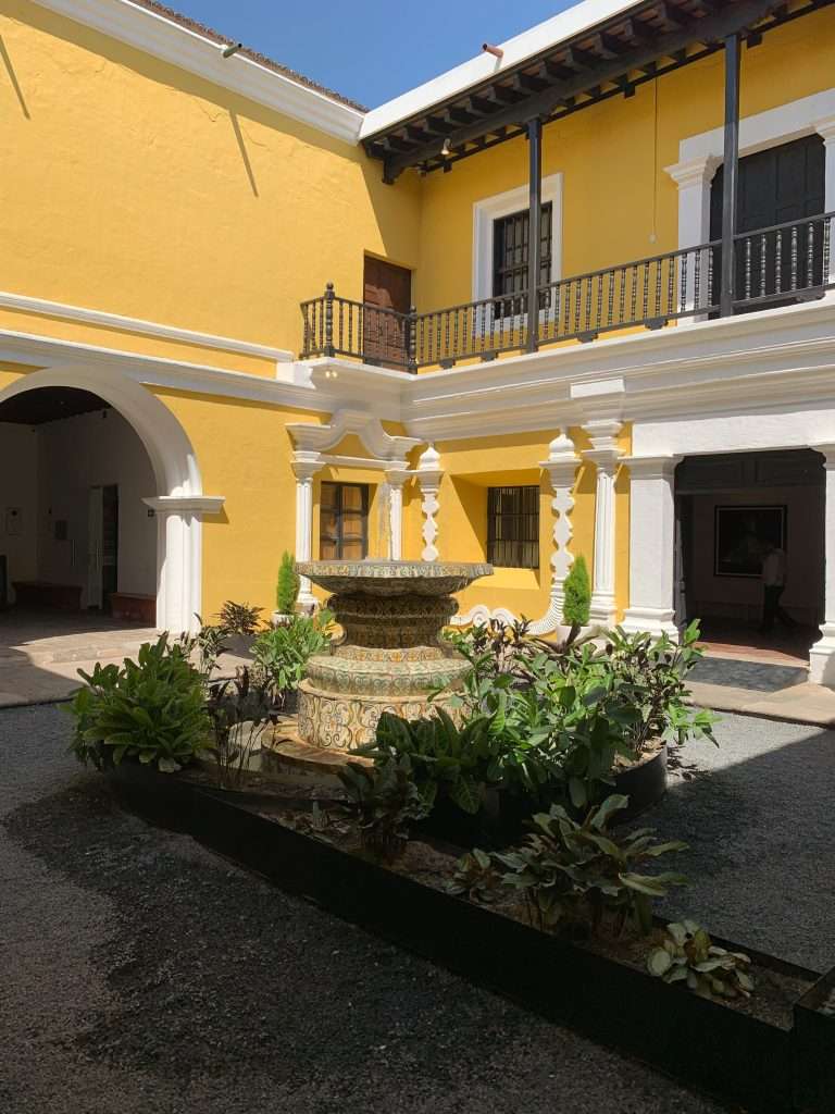 Image shows the view from within the courtyard of the Museo Nacional de Art de Guatemala. A visit to the museum is perfect for those with only one day to spend in Antigua Guatemala.