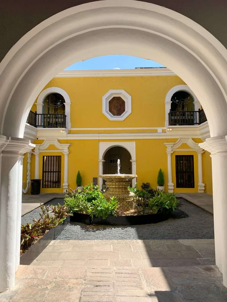 Image shows the view looking toward the courtyard of the Museo Nacional de Art de Guatemala. A visit to the museum is perfect for those with only one day to spend in Antigua Guatemala.