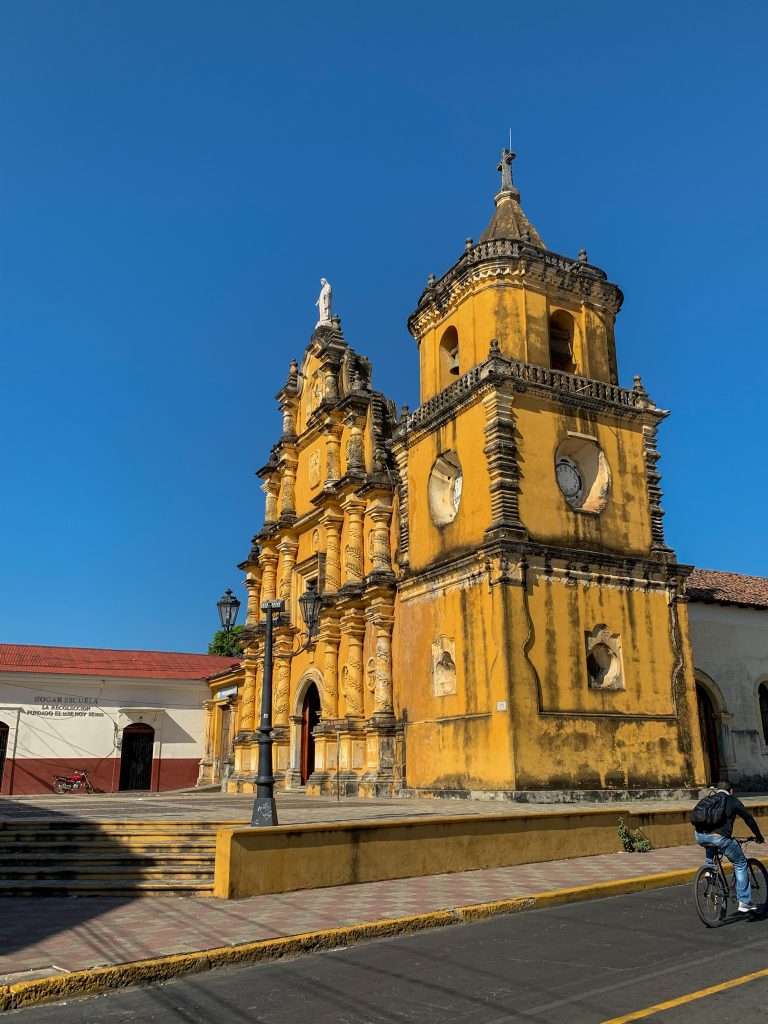 Image shows the Iglesia de la Recolección, a mustard yellowish coloured in León