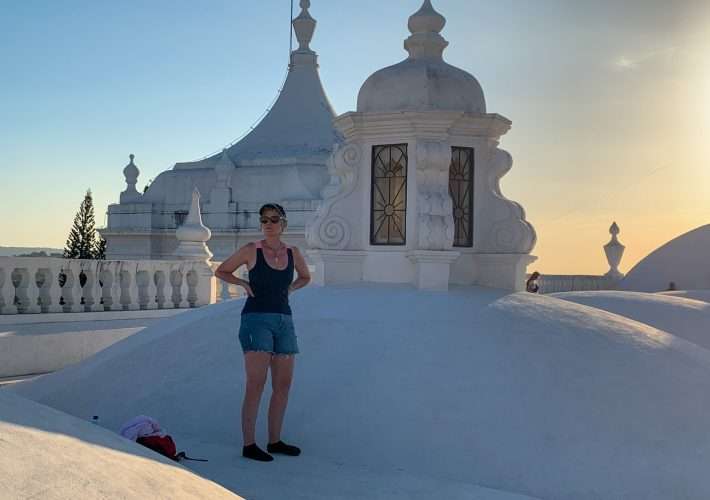 The author of this blog post stands upon the white rooftop of the Cathedral in Leon Nicaragua.