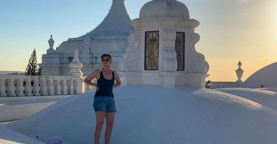 The author of this blog post stands upon the white rooftop of the Cathedral in Leon Nicaragua.