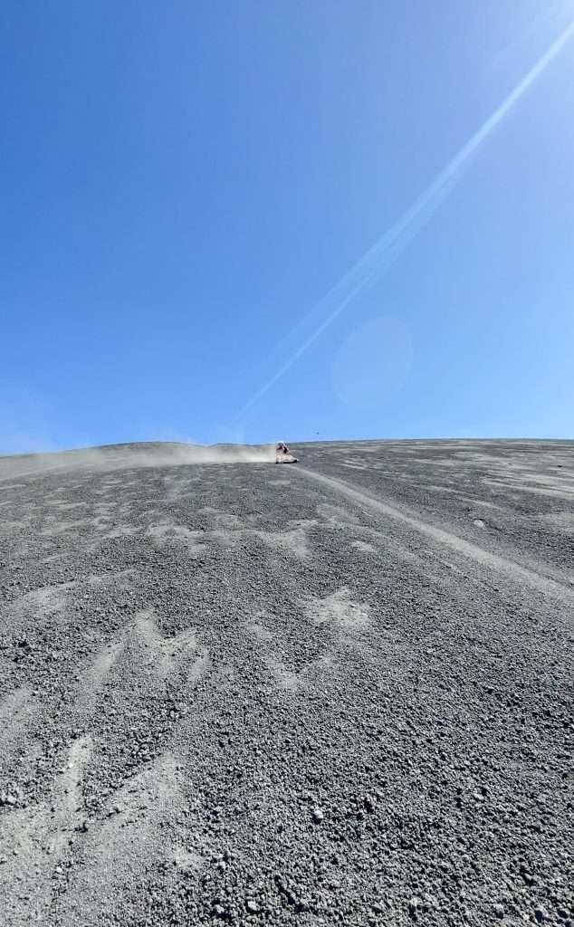 The author of this blog post from a distance sliding down the Cerro Negro active volcano in Nicaragua. Known as volcano boarding this is a must do activity when visiting the city of Leon.