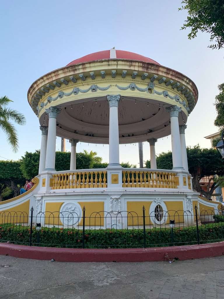 The yellow and white bandstand that takes centre stage in Granada Nicaragua's Central Park.