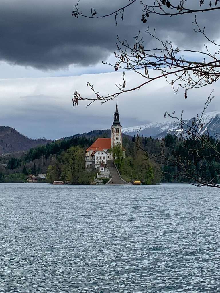 A view of Bled Island taking visible while walking around Lake Bled