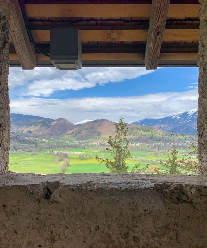 A view of the surrounding plains taken from inside Bled Castle with the walls of the castle acting as a frame for the image.