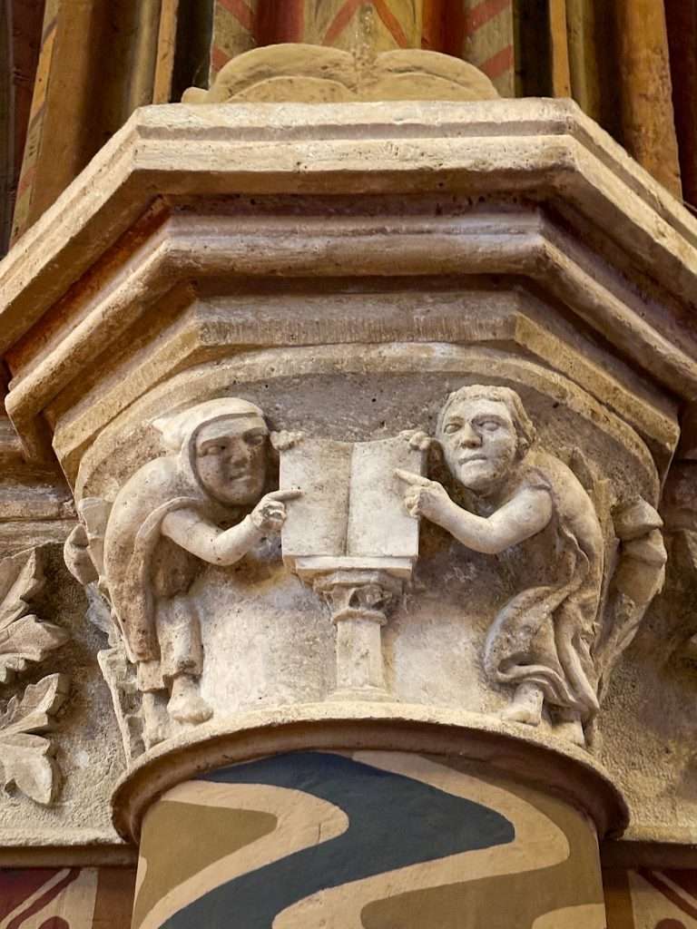 A close up view of a stone carving inside Mátyás Church depicting 2 characters. The carving is believed to date from around 1260. 