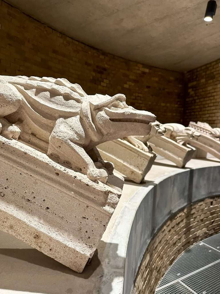 A closer view of a crocodile carved from stone and located within the Lapidarium museum in Budapest.