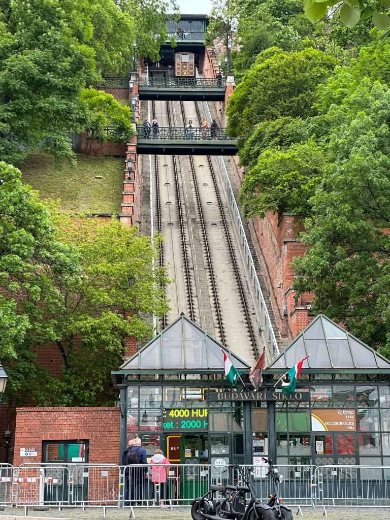 A view of the funicular in Budapest from street level looking up toward the top.