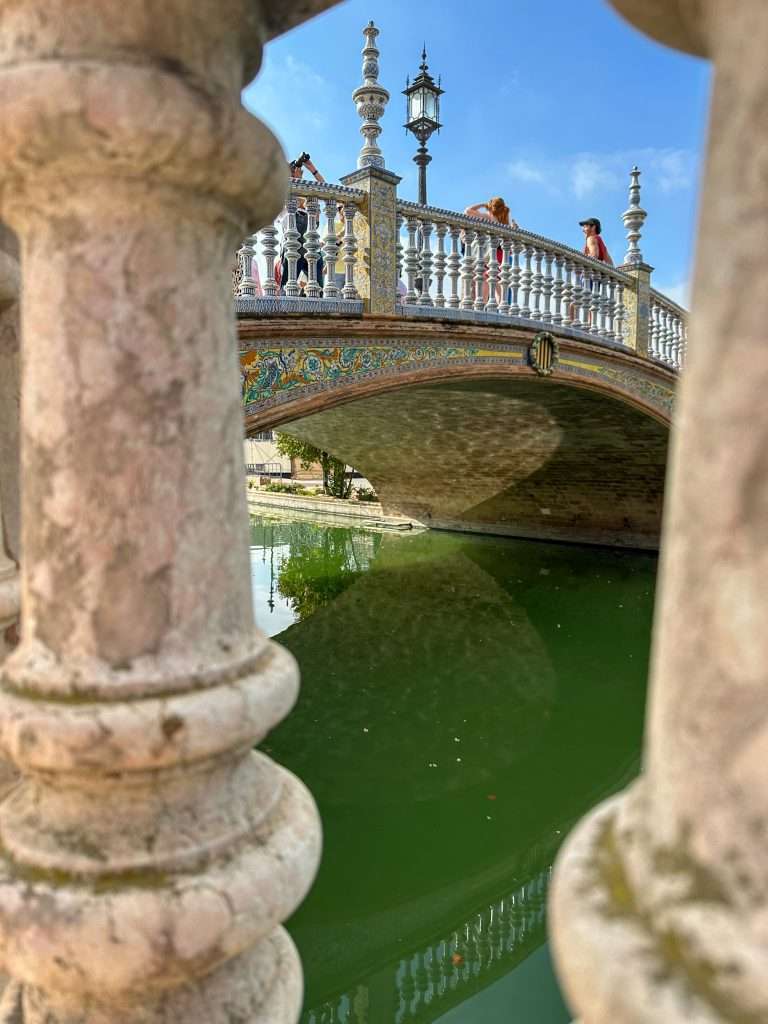 Photo shows the Venetian style bridge in Plaza de España, Seville 