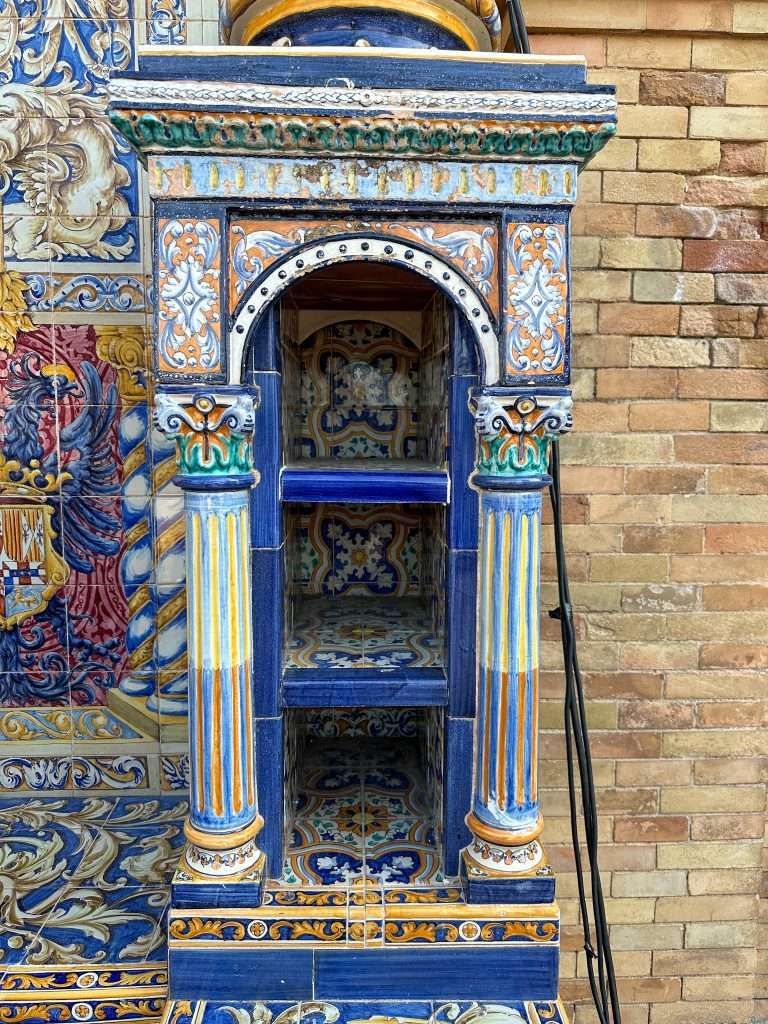 Photo shows some of the beautiful tiles at Plaza de España. A visit here is one of the best things to do in Seville 