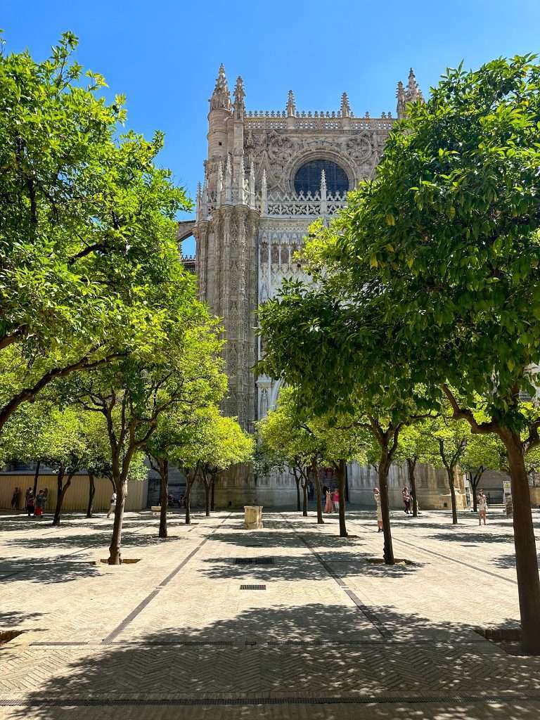 Image shows an external view of Seville cathedral, a must see during any visit to Seville 