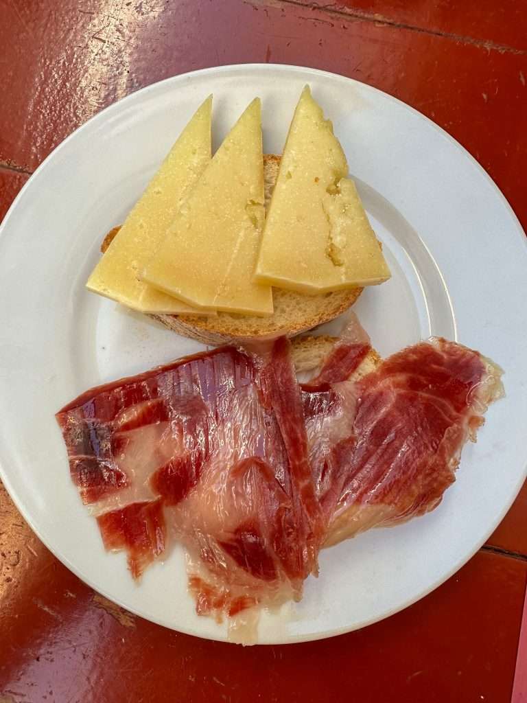 Photo of Iberian ham and cheese, part of a tapas selection. Eating tapas is one of the best things to do in Seville. 