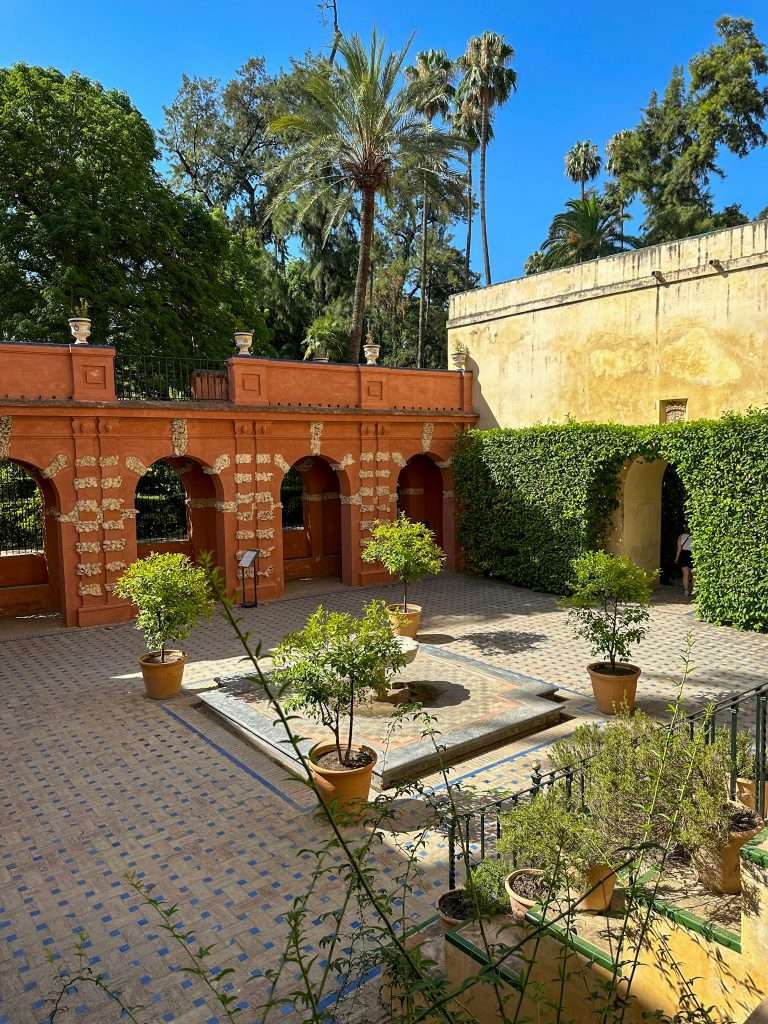 Image shows a courtyard garden within the grounds of the Royal Alcázar