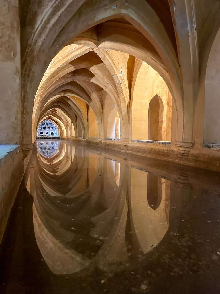 Image shows an indoor part of the beautiful Royal Alcazar, a must see when visiting Seville