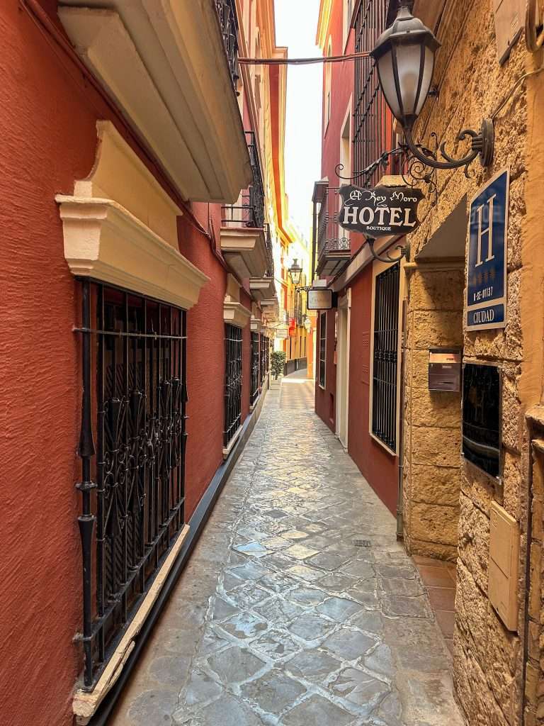 Image shows a street view within the old town of Seville, one of the best areas to stay in Seville 