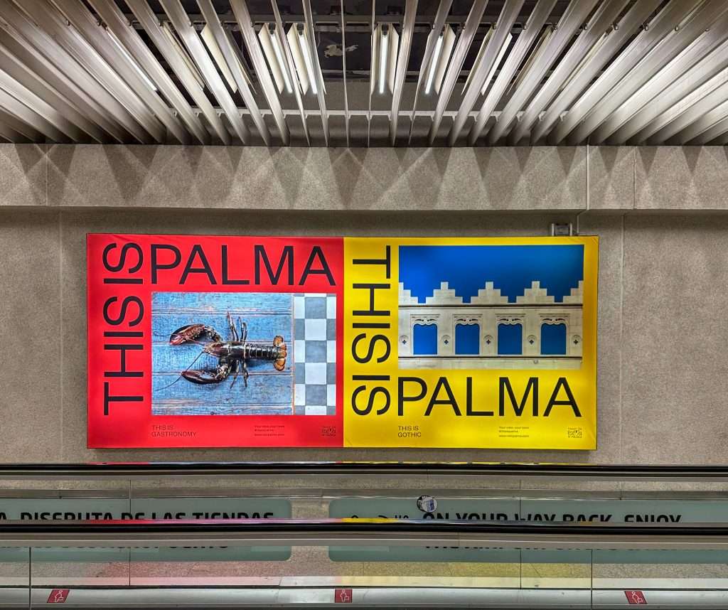 A 'This is Palma' sign in the airport at Palma. One sign is red and features a lobster and the other is yellow and features a gothic architectural design.