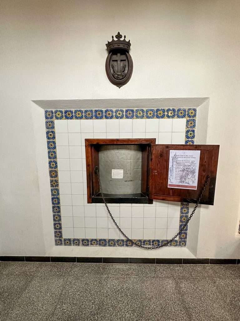View of the torno in one of the walls at the Santa Clara Convent in Palma. Place your money inside the wooden turnstile and a Nun will turn the torno, take your money and replace it with the cookies you have ordered. 