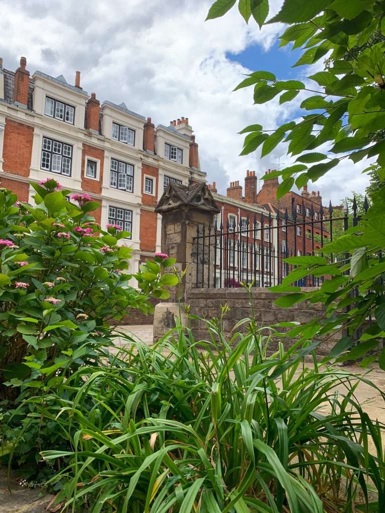 A view of a street and gardens in the town of Eton, easily visited during a day trip to Windsor.