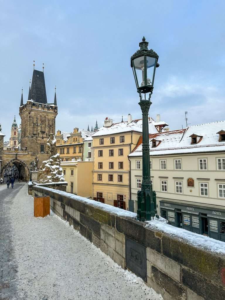 Images shows one of the lamps on the Charles Bridge in Prague during daylight hours. Each night during the Prague Christmas Markets visitors can watch the lamps being lit.