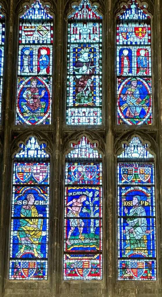 Stained glass in Canterbury Cathedral, including the oldest piece in Britain. Depicting scenes in bright colours, with the dominant colour being blue. 