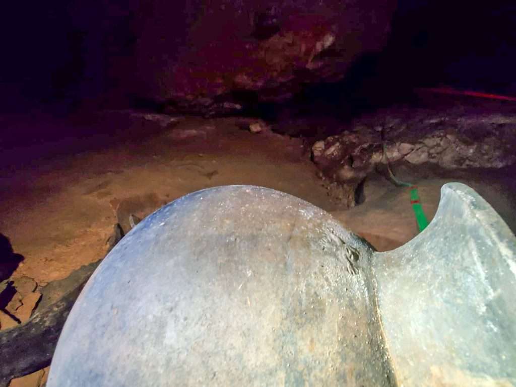 Image shows a pottery pot found in the ATM Cave commonly called the monkey pot after the small design located near the rim of the pot. Only 4 artefacts have been found in central America with this little design on them. 