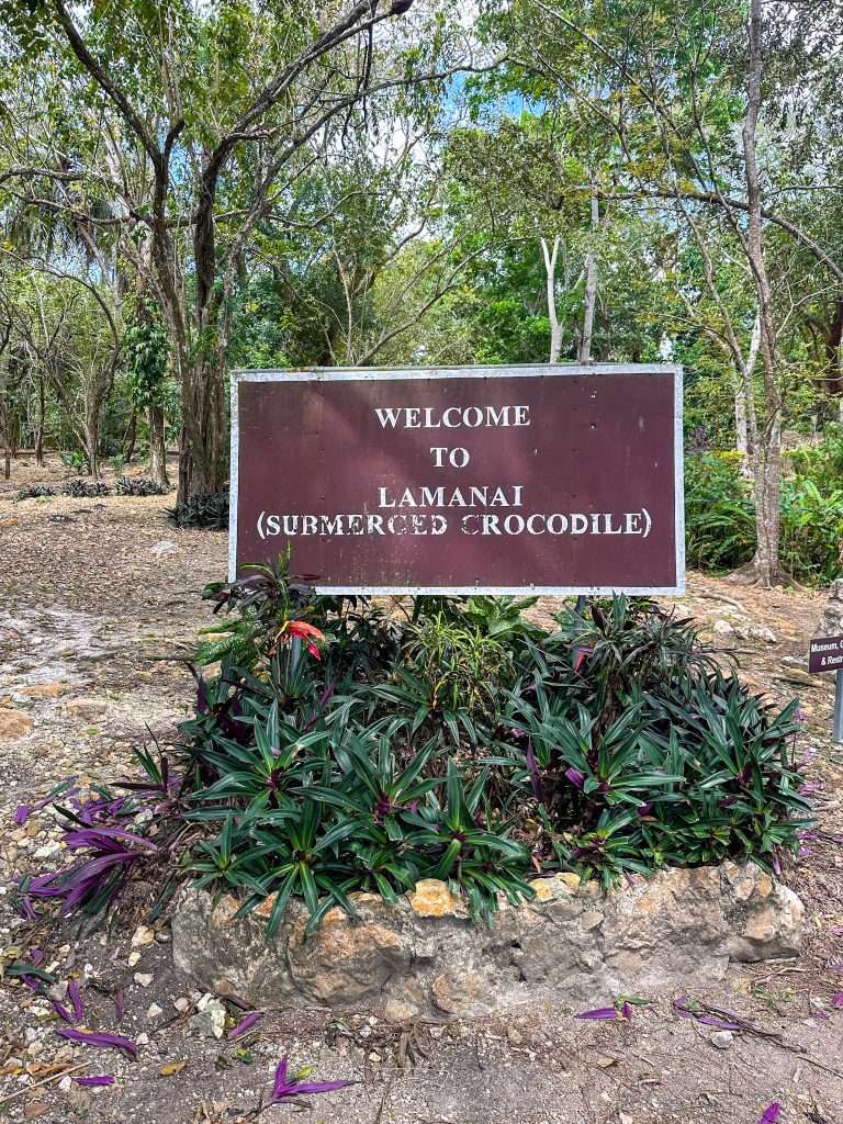 Image shows the Welcome to Lamanai sign which greets visitors to Lamanai archeological site