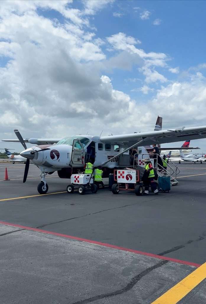 Image shows a small propeller plane operated by Tropic Air in Belize